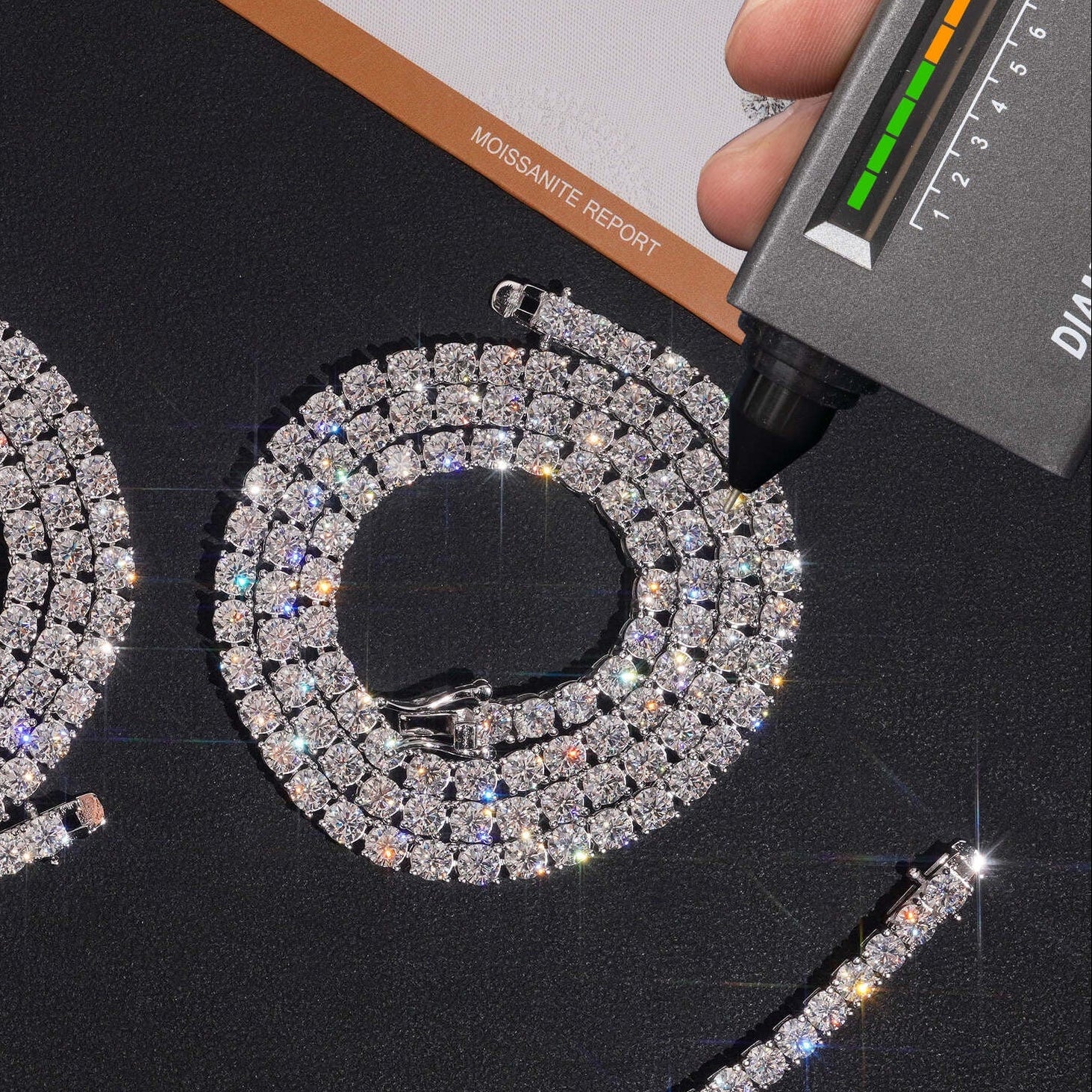 Diamond necklace and earrings with a diamond grading tool on a black background.