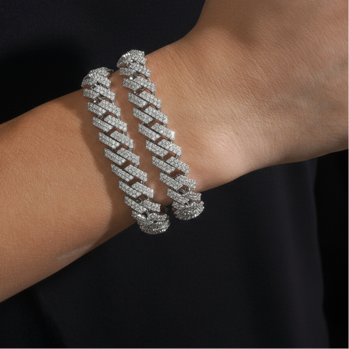 Two bracelets on arm, black background